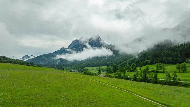 Aerial drone hyperlapse of Gesause national park Austria with low hanging clouds