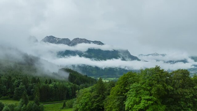 Aerial drone hyperlapse of Gesause national park Austria with low hanging clouds