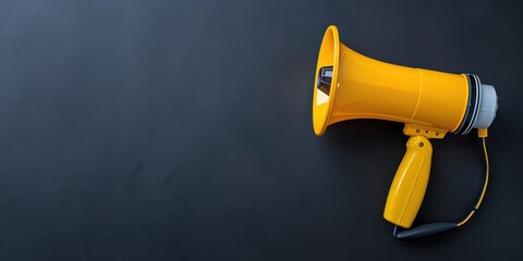 Yellow megaphone on a dark background, symbolizing communication and announcement, ideal for marketing and promotional materials.
