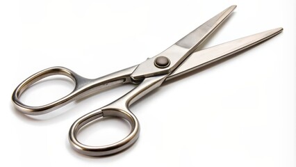 Obraz premium Isolated open scissors lying flat on a clean white background, blades splayed apart, awaiting their next cutting task.