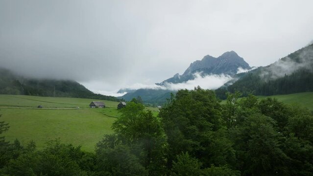 Aerial drone view of Gesause national park in Austria in spring with clouds