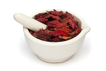 Close-up of Dry Organic Hibiscus (Hibiscus rosa-sinensis) flowers, in white ceramic mortar and pestle, isolated on a white background.