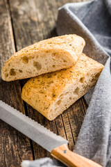 Italian ciabatta bread on wooden table.