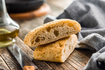 Italian ciabatta bread on wooden table.