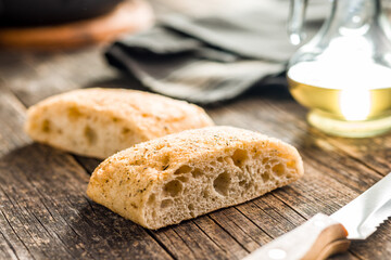 Italian ciabatta bread on wooden table.