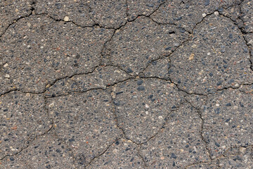 a part of a highway covered with cracked asphalt