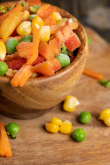 a mixture of quick-frozen corn, peas, peppers, and carrots