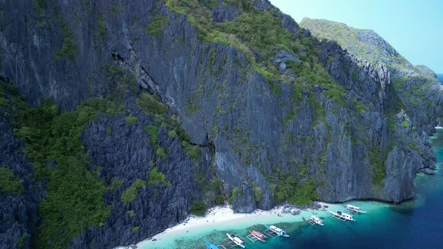 Aerial footage of Talisay Beach on a sunny summer day in Tapiutan Island, El Nido, Philippines