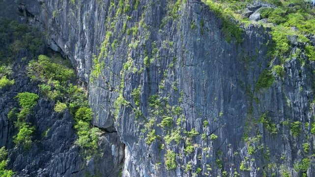 Pull-back drone footage of the rocky rapids around Talisay Beach in El Nido, Palawan, Philippines