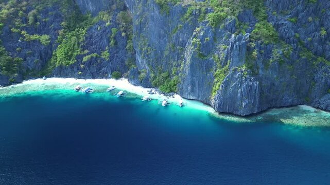 Aerial footage of Talisay Beach on a sunny day in Tapiutan Island, El Nido, Palawan, Philippines