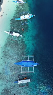 Aerial footage of the boats moored along Talisay Beach in Tapiutan Island, El Nido, Philippines
