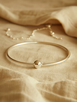 Delicate screwball bracelet, handcrafted in gleaming silver. Minimalist design, perfect for everyday elegance.