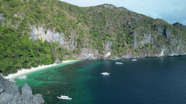 Aerial view of boats moored off Seven Commandos Beach on a sunny day in El Nido, Palawan, Philippine