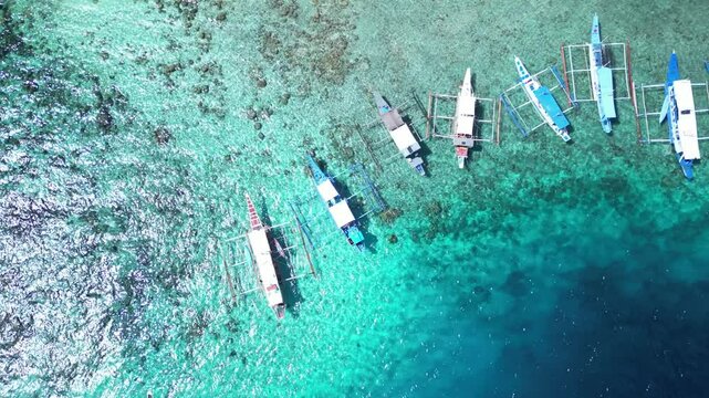 Aerial view of boats moored off Seven Commandos Beach on a sunny day in El Nido, Palawan, Philippine