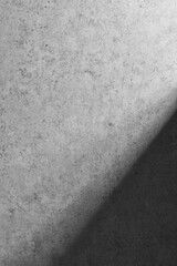 A textured wall with natural shadows illuminated by natural light.