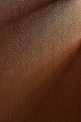 A textured wall with natural shadows illuminated by natural light.