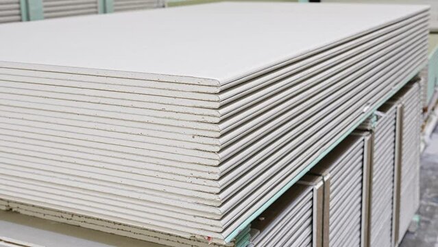 gypsum board on a rack in a hardware store. sale of building materials for repair and construction.