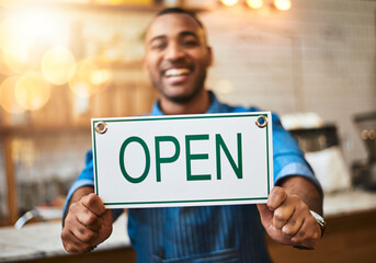 Coffee shop, open sign and portrait of man in cafe for small business, startup and retail store. Restaurant, cafeteria and happy waitress, barista and owner by counter for service, help and welcome