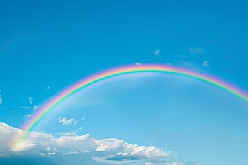 A rainbow spanning a clear blue sky with fluffy clouds, A vibrant rainbow stretching across a clear blue sky