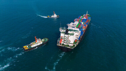 Logistics and container loading by large barges by sea in a harbor full of containers waiting to be transported.