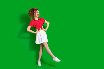 Full length photo of lovely young lady look empty space posing model dressed stylish red retro garment isolated on green color background