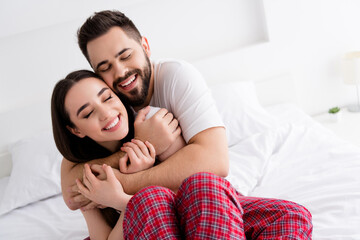 Fototapeta premium Photo of good mood adorable boyfriend girlfriend sleepwear hugging indoors home bedroom