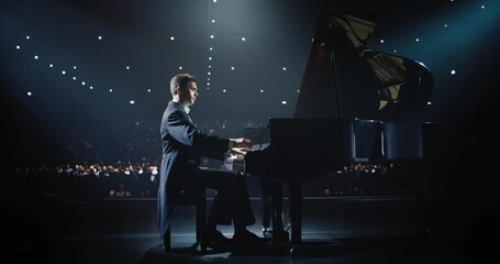 On a Dimly Lit Concert Stage, Male Pianist Delivers an Emotional Improvisation on a Grand Piano. Each Note Resounds Through the Concert Hall, Holding the Excited Audience Spellbound