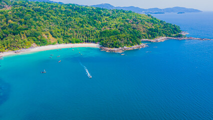 Obraz premium Paradise beach Phuket Patong. aerial top view amazing freedom beach small white sand beach with perfect nature. white wave hit the rock around island. green forest peaceful. green sea, landscape.