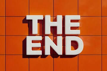 The End Text on Block Letter Tiles on Bright Orange Background. Minimalist Aesthetics