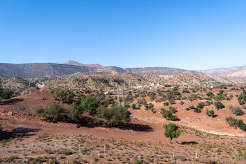 Morocco semi-deserts and mountains, north africa nature, Moroccan stone desert, red hills, villages and argan trees
