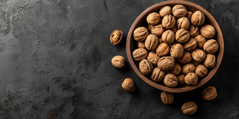 A bowl filled with a variety of whole walnuts, set against a dark, richly textured background, highlighting the natural beauty and simplicity of the nuts.