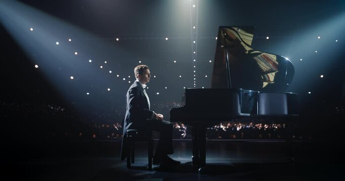 Talented Caucasian Pianist Enters the Stage and Starts to Create a Masterful Performance on a Grand Piano. Under Soft Stage Lights, His Fingers Move Across the Keys, Creating Beautiful Classical Music