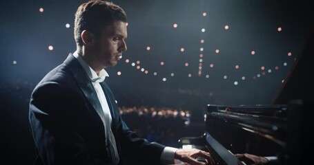 On a Dimly Lit Concert Stage, Male Pianist Delivers an Emotional Improvisation on a Grand Piano. Each Note Resounds Through the Concert Hall, Holding the Excited Audience Spellbound. Handheld Footage