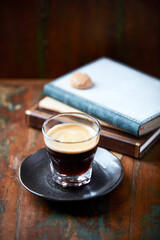 Coffee in glass cup on dark background. Close up. Copy space.