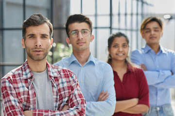 We mean business. Shot of a group of businesspeople with their arms crossed in an office.