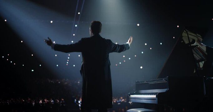 Caucasian Male Pianist Standing Beside the Grand Piano, Receiving Applause and Cheers From the Audience. Successful Musician Bows Deeply, Expressing His Gratitude for Their Enthusiastic Praise