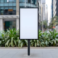 Blank outdoor billboard in an urban environment, surrounded by commercial buildings and greenery, ready for advertisement.