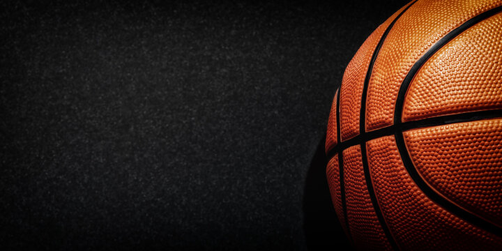 Dark web banner with detailed orange basketball and copy space for text. Professional sports backgrounds