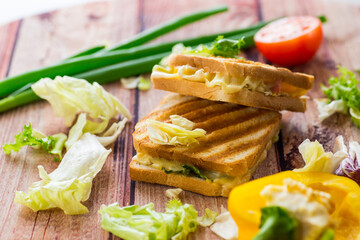 fried toasts with filling, salad leaves, tomatoes