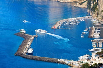 Aerial view of Marina Grande in Capri, Italy, showcasing vibrant blue waters of Mediterranean sea,...