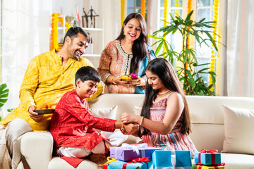 Indian family with kids celebrating rakhi or rakshabandhan festival or diwali