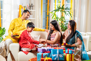 Indian family with kids celebrating rakhi or rakshabandhan festival or diwali