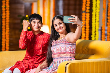 Fototapeta premium Indian brother and sister enjoying togetherness while celebrating rakhi, rakshabandhan or bhai dooj