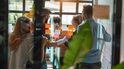 Diverse team brainstorming with sticky notes in a modern office with natural light and green plants
