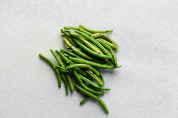Overhead view of green beans on a marble countertop, top view of green beans, haricot verts on a white countertop