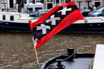 Amsterdam flag with three big X signs waving in the wind