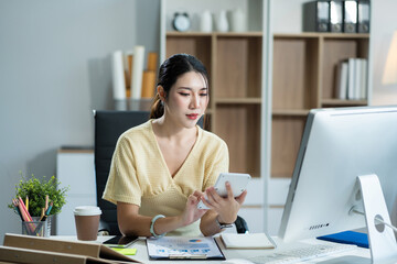 lifestyle of office workers Woman calculating expenses and using laptop. Home office. Work place. Lifestyle.