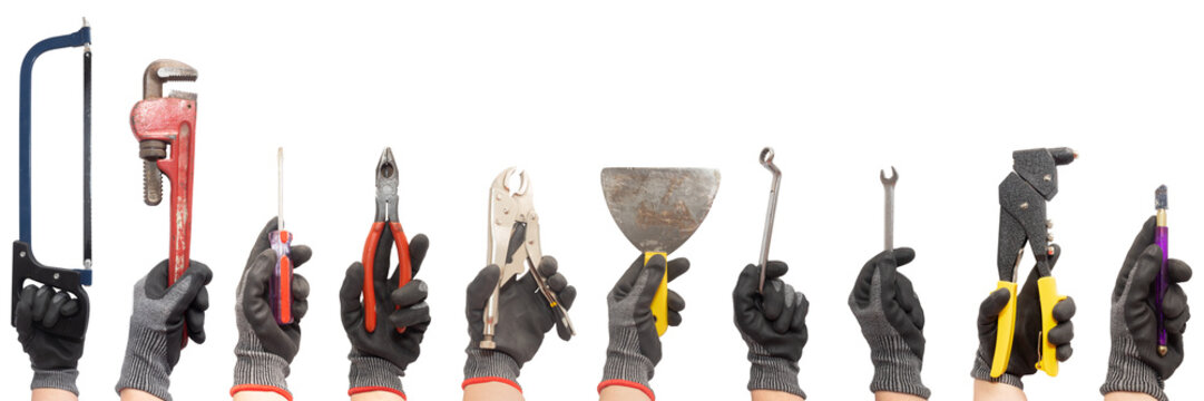 Ten hands wearing safety gloves hold different home work tools on a white background. Carpentry tools. Plumbing tools. Masonry tools.