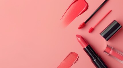 Liquid lipstick and applicator on pink background with lip gloss tube and brush on coral surface Overhead view with space for text