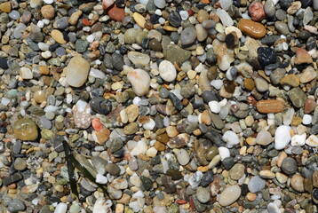 Wet round stones background, texture. pebble beach stones background seamless texture for design. Natural rounded gravel at sea shore Nature background texture pattern